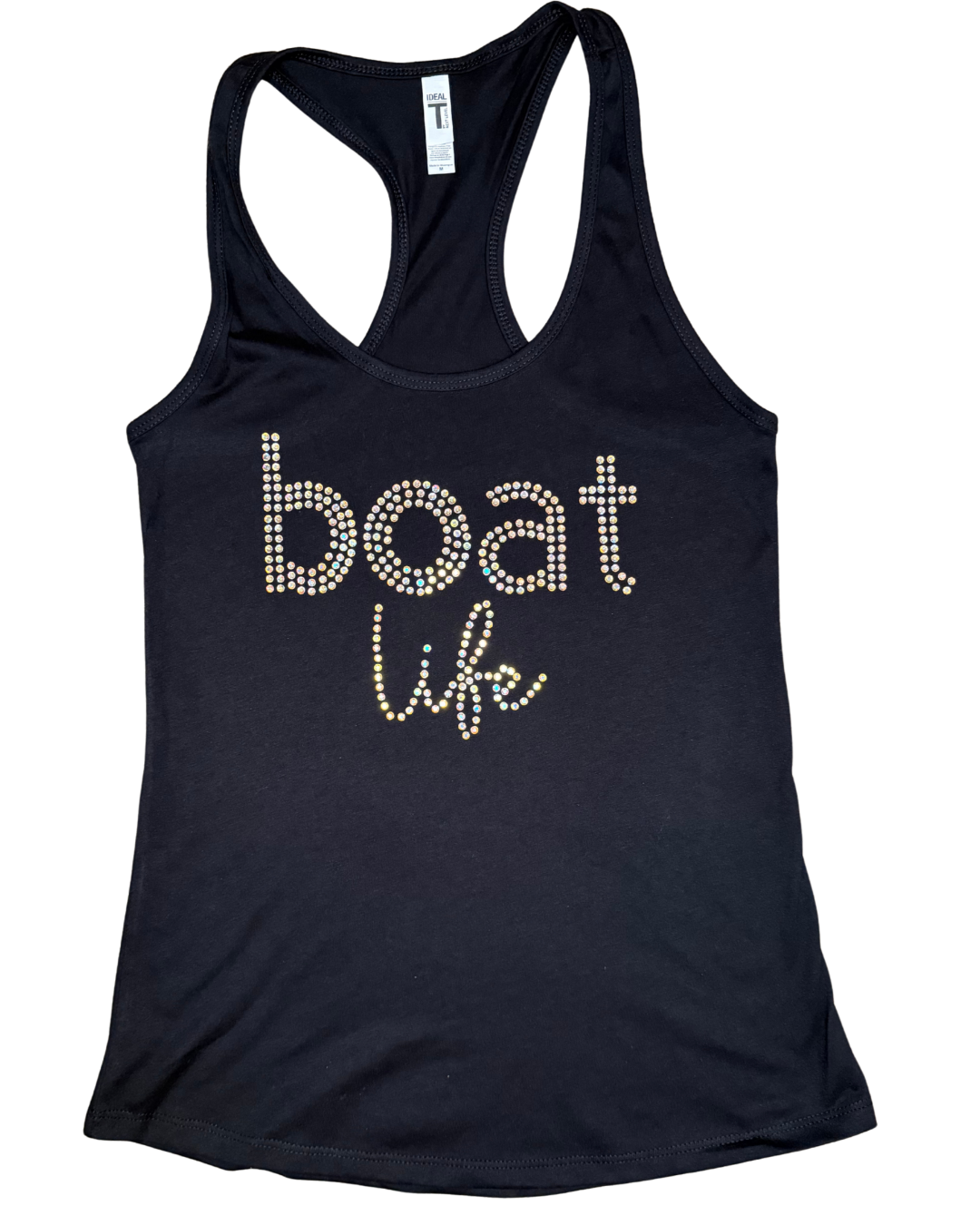 Black women's racerback tank top featuring the phrase "boat life" in sparkling rhinestone lettering. The word "boat" is displayed in lowercase block letters, with "life" in a cursive script beneath it. The tank top is laid flat on a black-and-gray checkered background.