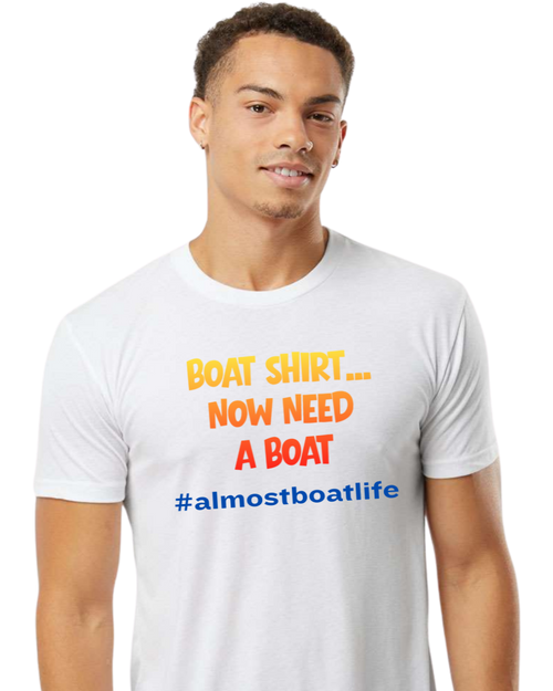 A man wearing a white crewneck t-shirt with the text 'BOAT SHIRT.