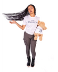 A woman with long dark hair wearing a white graphic t-shirt that says 'a lil Bougie' and dark gray pants, holding a brown plush dog wearing a matching t-shirt, with word Bougie AF
