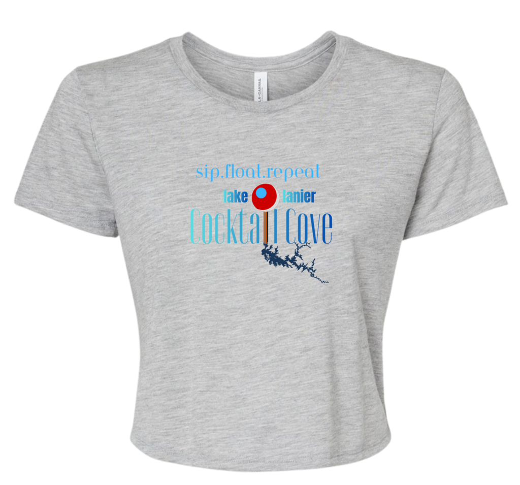 A light heather gray short-sleeve crop top t-shirt with a graphic on the front that reads 'sip, float, repeat' and 'lake Lanier Cocktail Cove' in blue and red text with a pin illustration showing where the cove is.