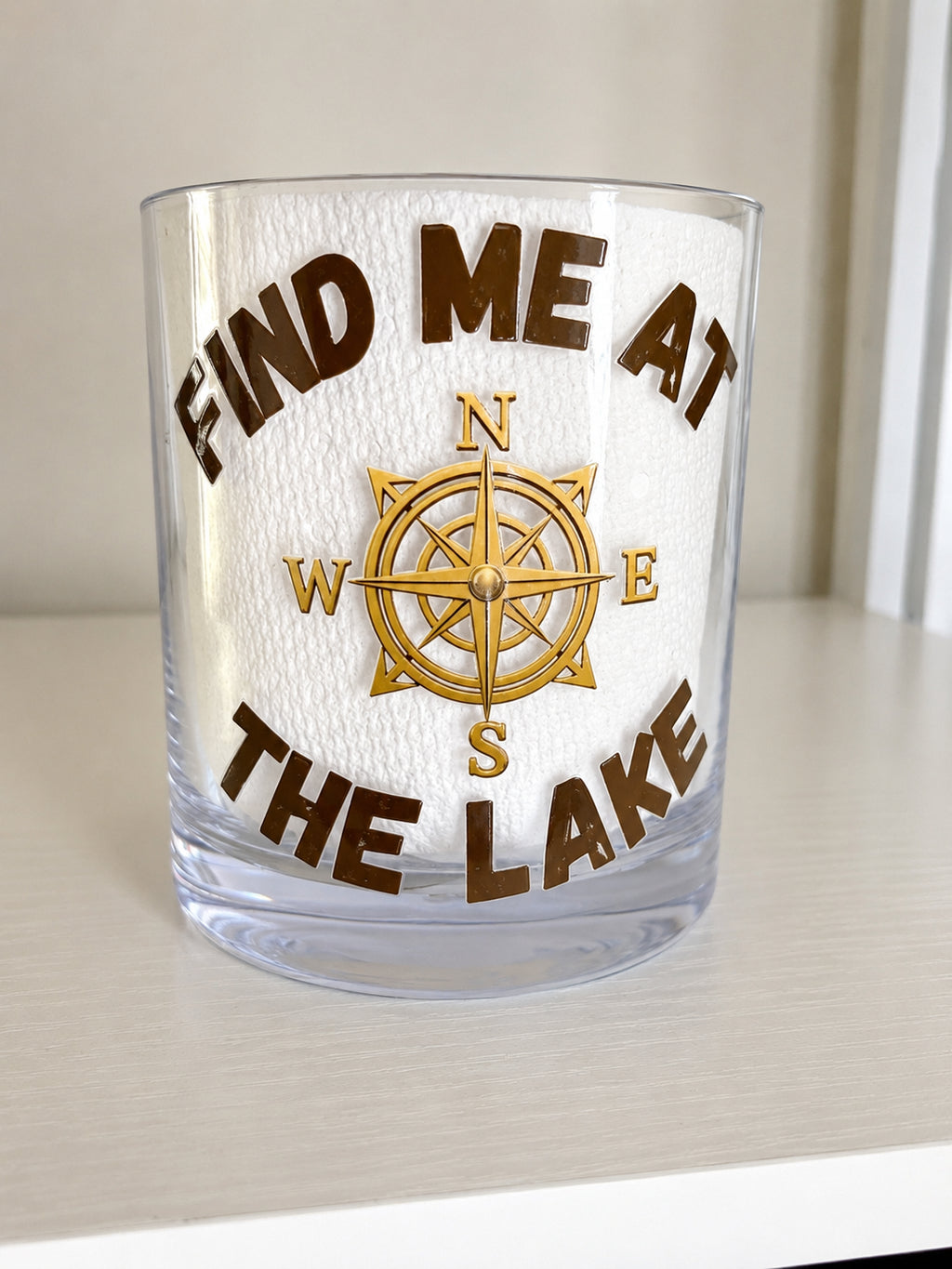 Lowball shatterproof glass with the wording "FIND ME AT THE LAKE "  with a compass graphic