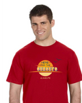 A smiling man wearing a red short-sleeve t-shirt with a yellow and orange graphic on the chest that reads 'HERE FOR THE SUNSETS' and 'LAKELIFE'.