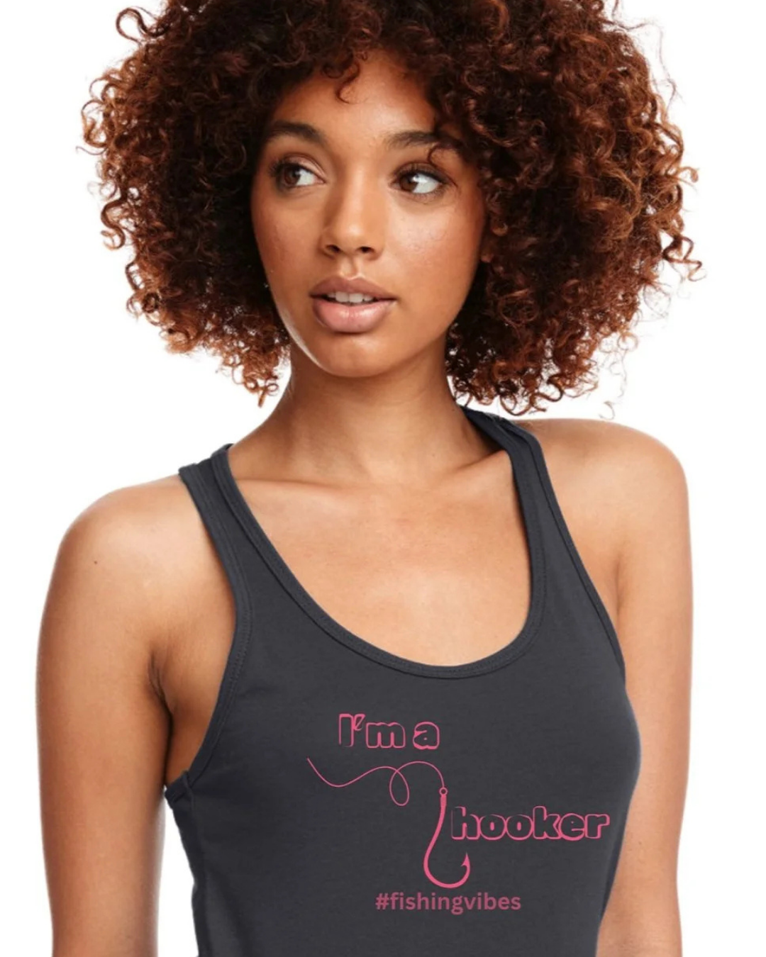 A woman with curly brown hair wearing a black racerback tank top with pink text that reads 'I'm a hooker' and '#fishingvibes' on a white background.