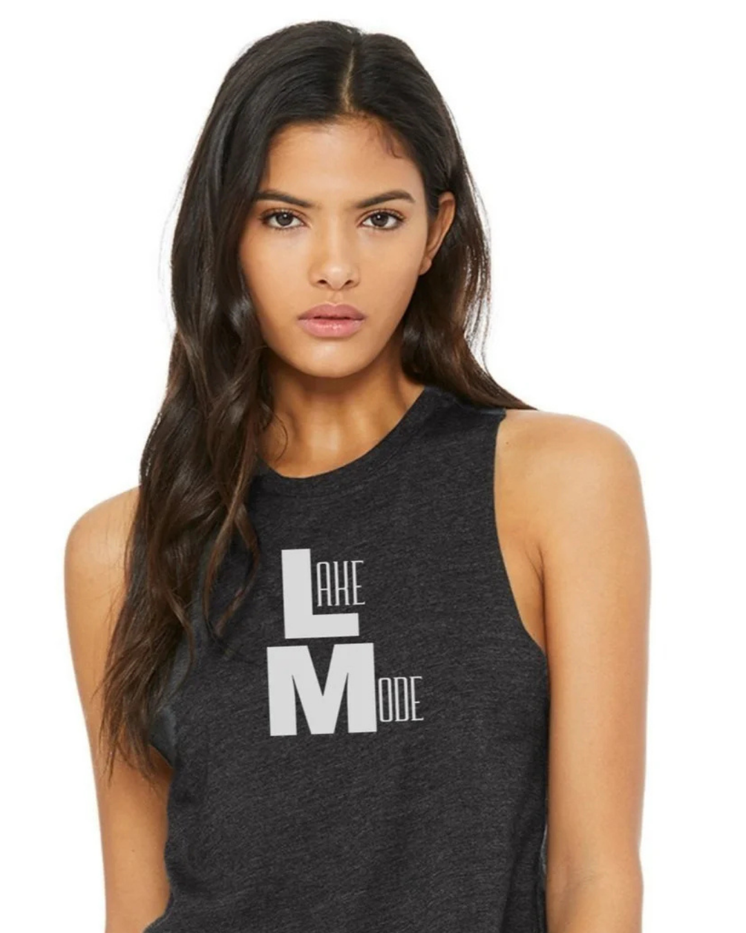 A woman wearing a dark heather gray sleeveless tank top with a white graphic print that reads 'LAKE MODE' on the front, set against a plain white background.
