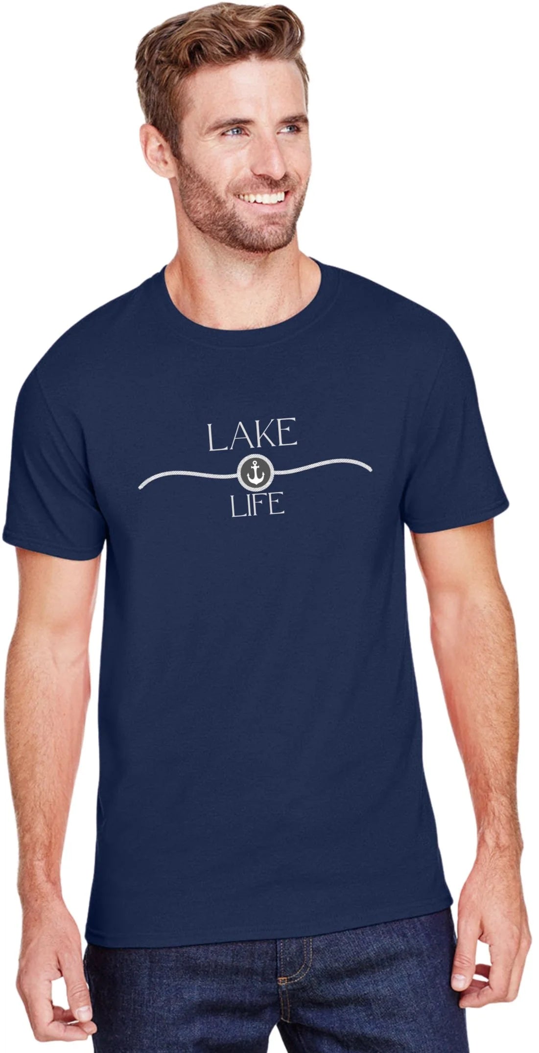 A man wearing a navy blue crewneck t-shirt with a white graphic that reads 'LAKE LIFE' and an anchor design, paired with dark blue jeans against a plain white background.
