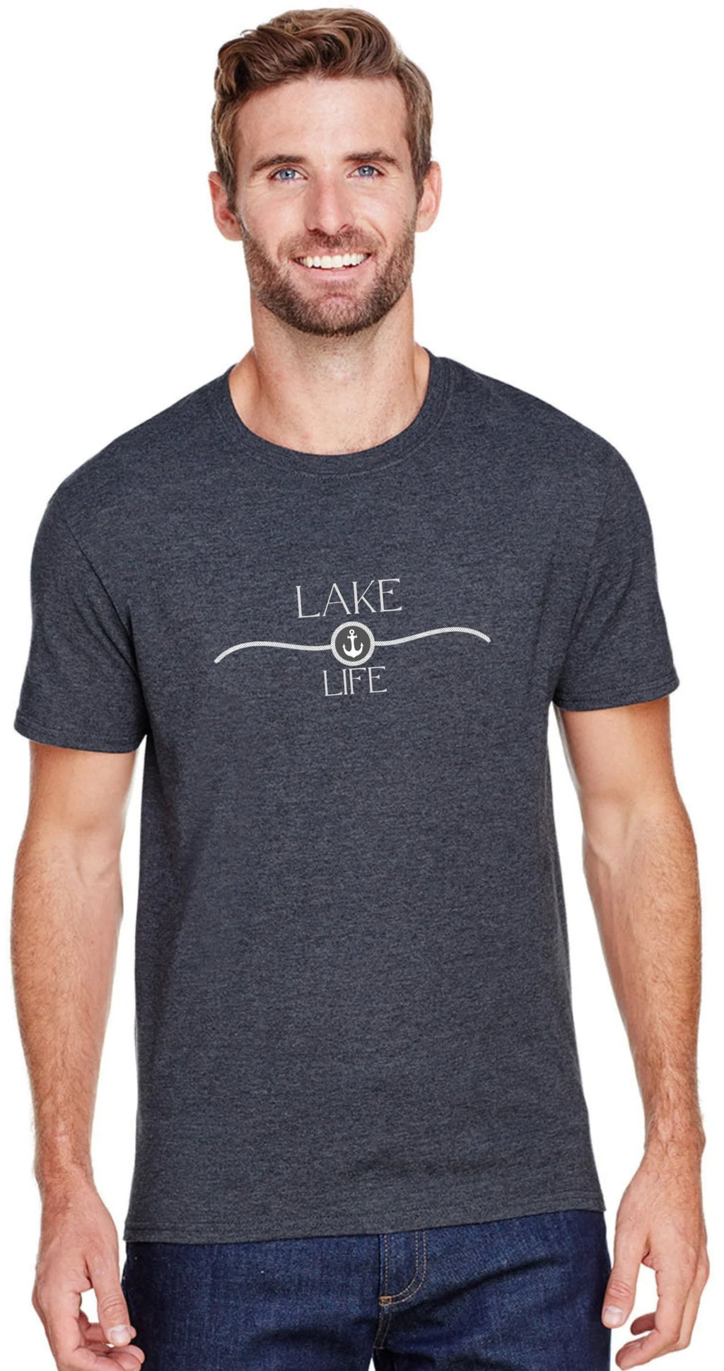 A man wearing a dark heather gray t-shirt with a white graphic that reads 'LAKE LIFE' and a boat anchor symbol, paired with blue jeans against a plain white background.