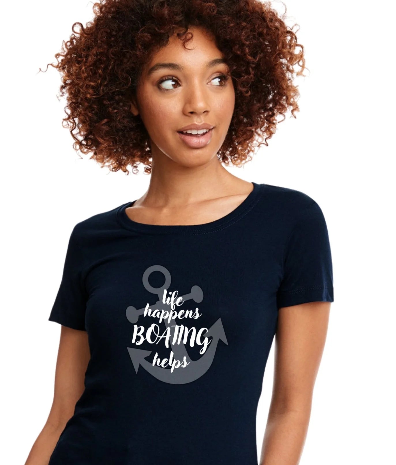 A woman with curly brown hair wearing a navy blue t-shirt with a white anchor graphic and the text 'life happens BOATING helps'.