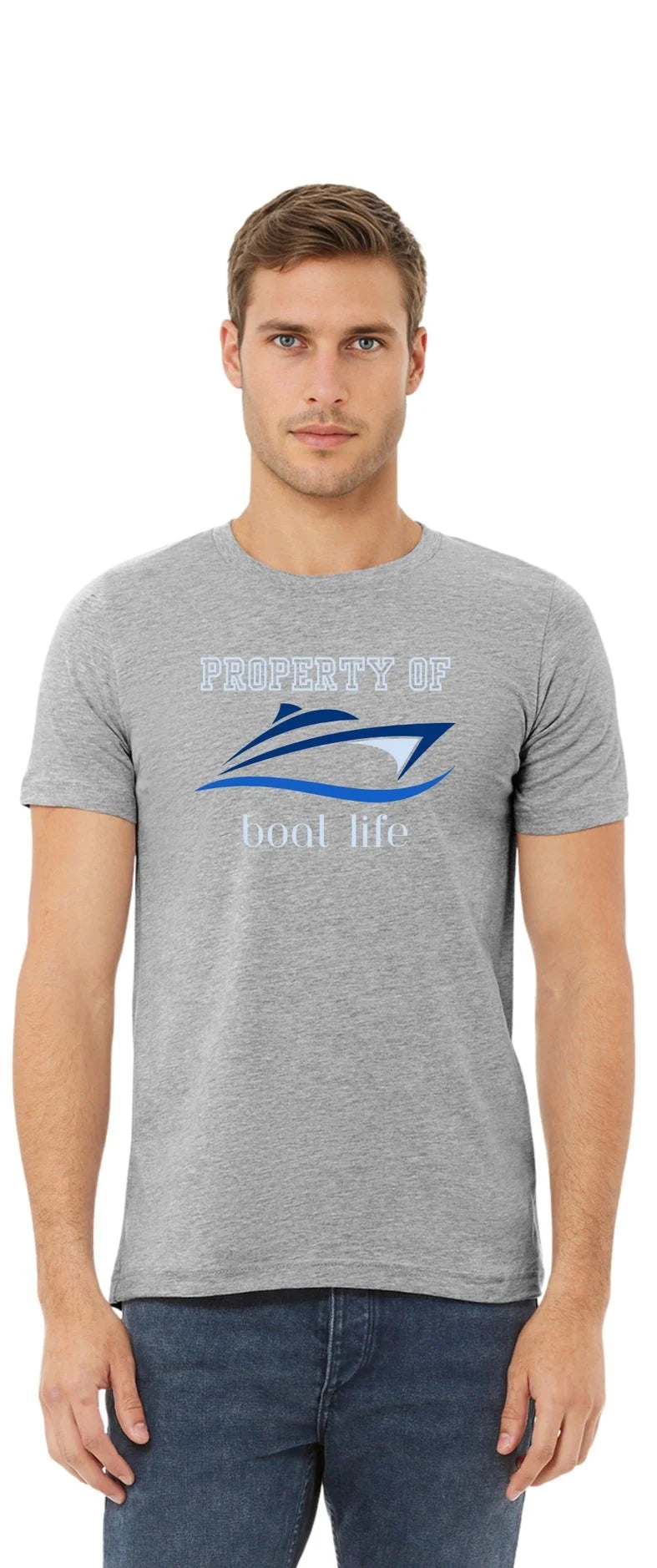 A man wearing a heather gray crewneck t-shirt with a blue and white graphic that reads 'PROPERTY OF Boat Life' and a boat illustration, paired with dark blue jeans, against a plain white background.