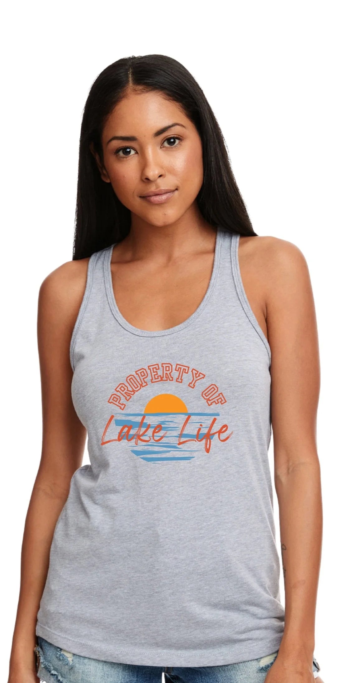 A woman modeling a light heather gray racerback tank top with a retro-style 'Property of Lake Life' graphic on the chest, set against a plain white background.