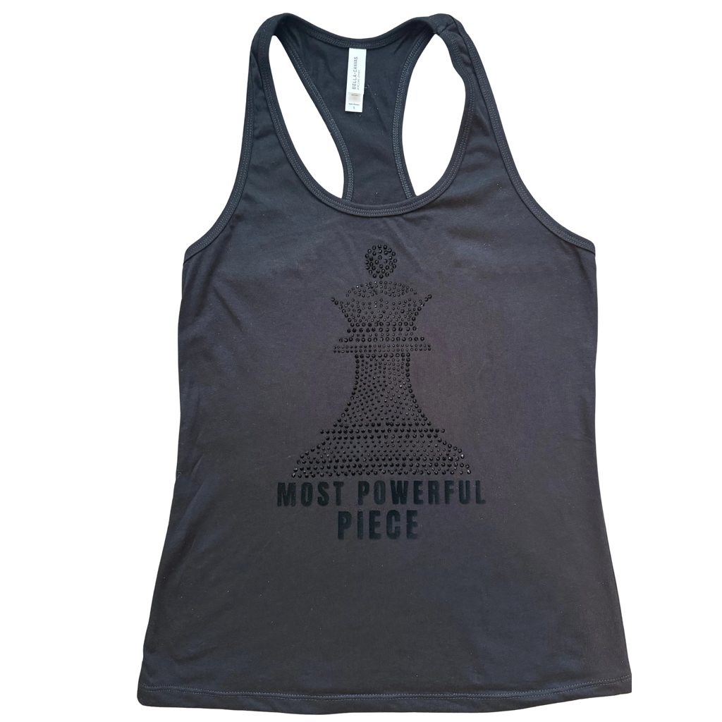 Black racerback  tank top with  black chess queen graphic made of rhinestone. with the text 'MOST POWERFUL PIECE' below in bold black letters.