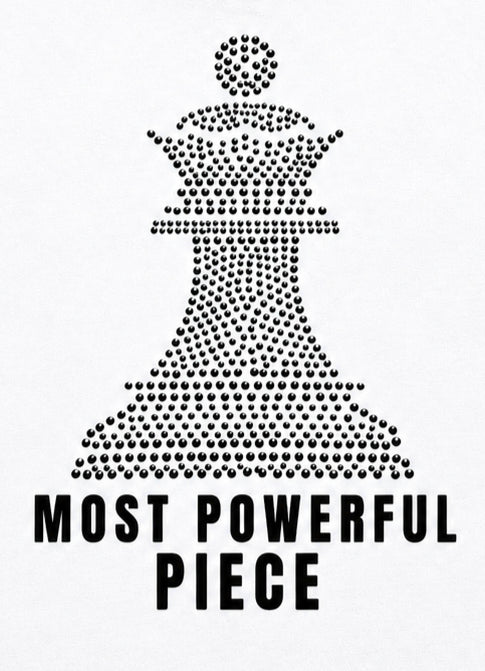 White tank top with  black chess queen graphic made of rhinestone. with the text 'MOST POWERFUL PIECE' below in bold black letters.