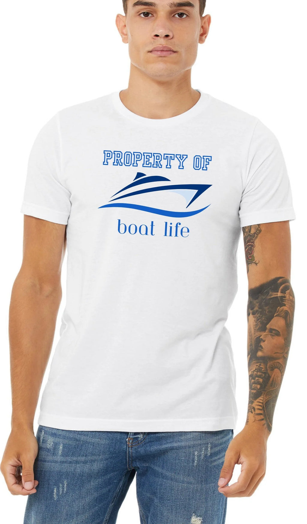 A man wearing a white crewneck t-shirt with a graphic that reads 'PROPERTY OF boat life' and features a speedboat illustration, paired with blue jeans.t 