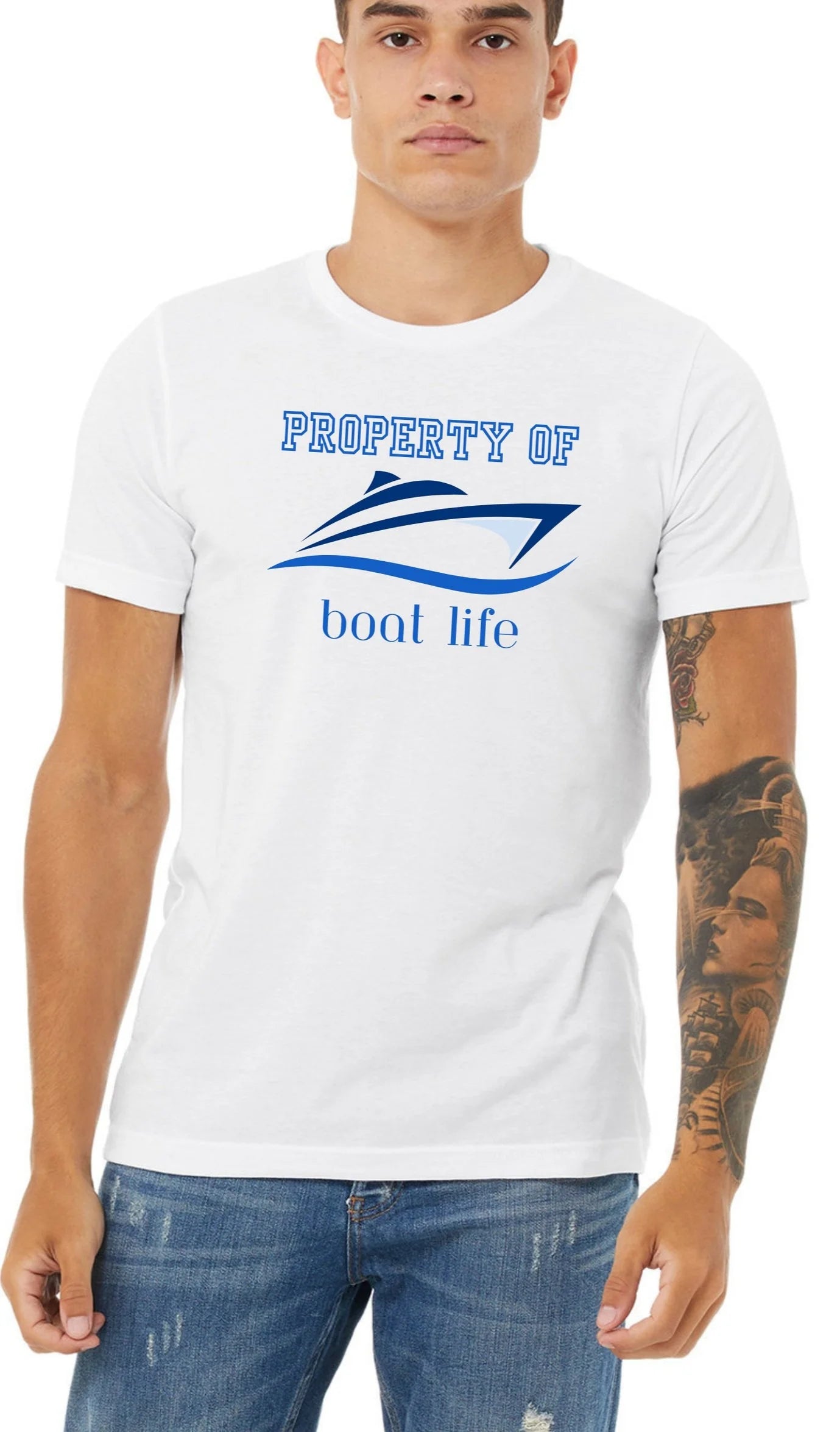 A man wearing a white crewneck t-shirt with a graphic that reads 'PROPERTY OF boat life' and features a speedboat illustration, paired with blue jeans.t 